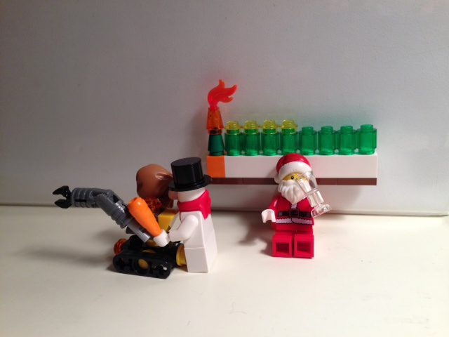 Because he's the Man, Santa gets to chill under the menorah while Snowman does all the work.