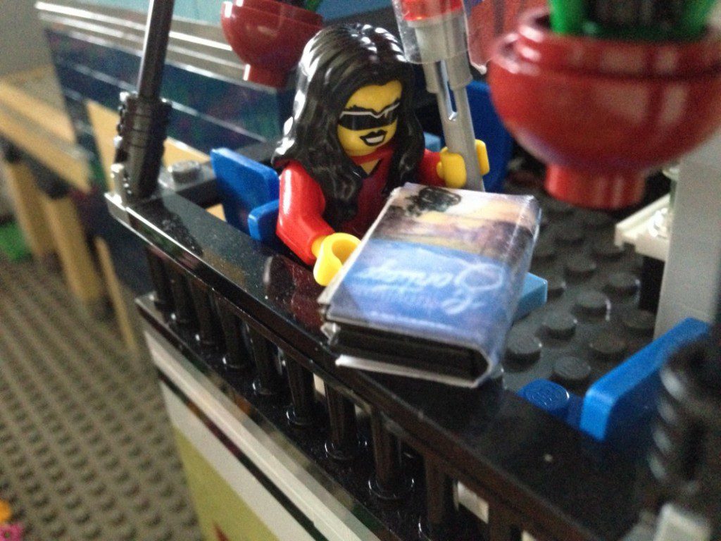Lego Tina reads her ARC at an upstairs table of the Parisian Restaurant.